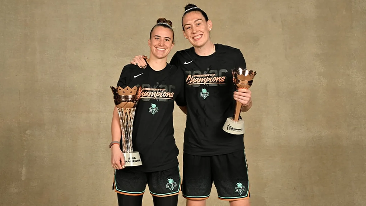 Sabrina Ionescu and Breanna Stewart hold the 2026 Commissioner's Cup and MVP trophies