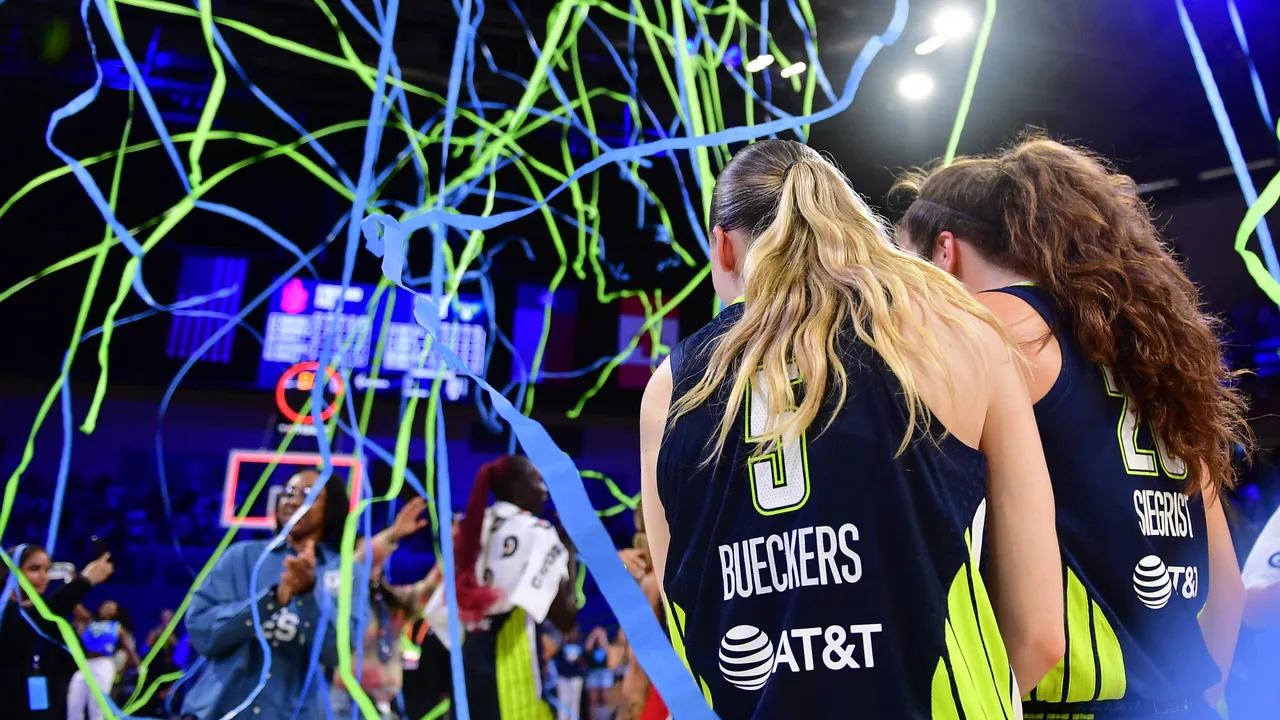 Dallas Wings players Paige Bueckers and Maddy Siegrist under celebration streamers