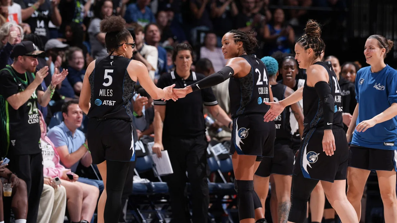 Olivia Miles and Napheesa Collier greet Minnesota Lynx teammates during a 2026 game