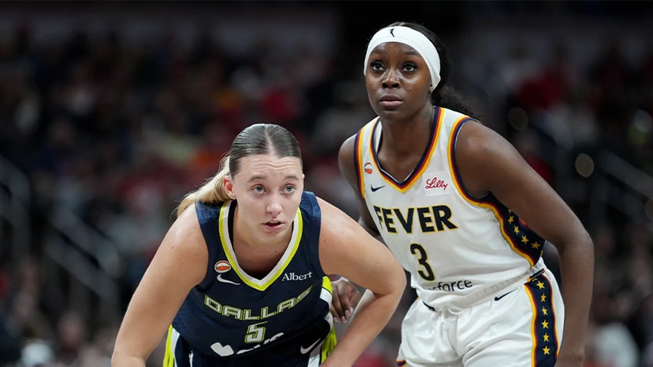Dallas and Indiana WNBA players positioning for a rebound during a game