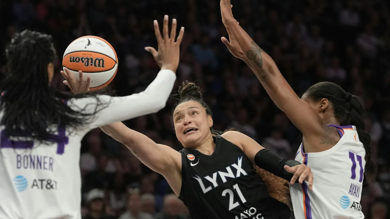 Minnesota Lynx player driving between two Phoenix Mercury defenders