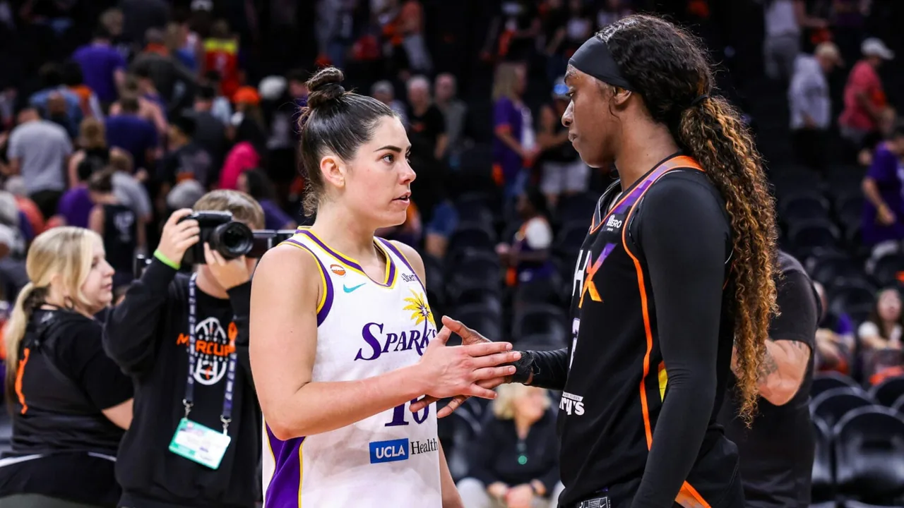 Kelsey Plum speaking with Phoenix Mercury guard Kahleah Copper on a WNBA court