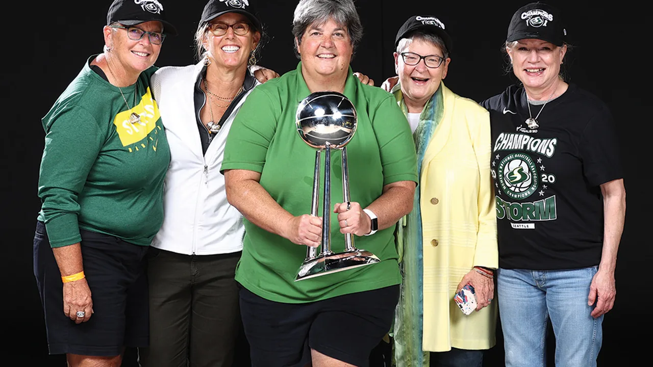Celeste Keaton with members of the Seattle Storm ownership group and the WNBA championship trophy