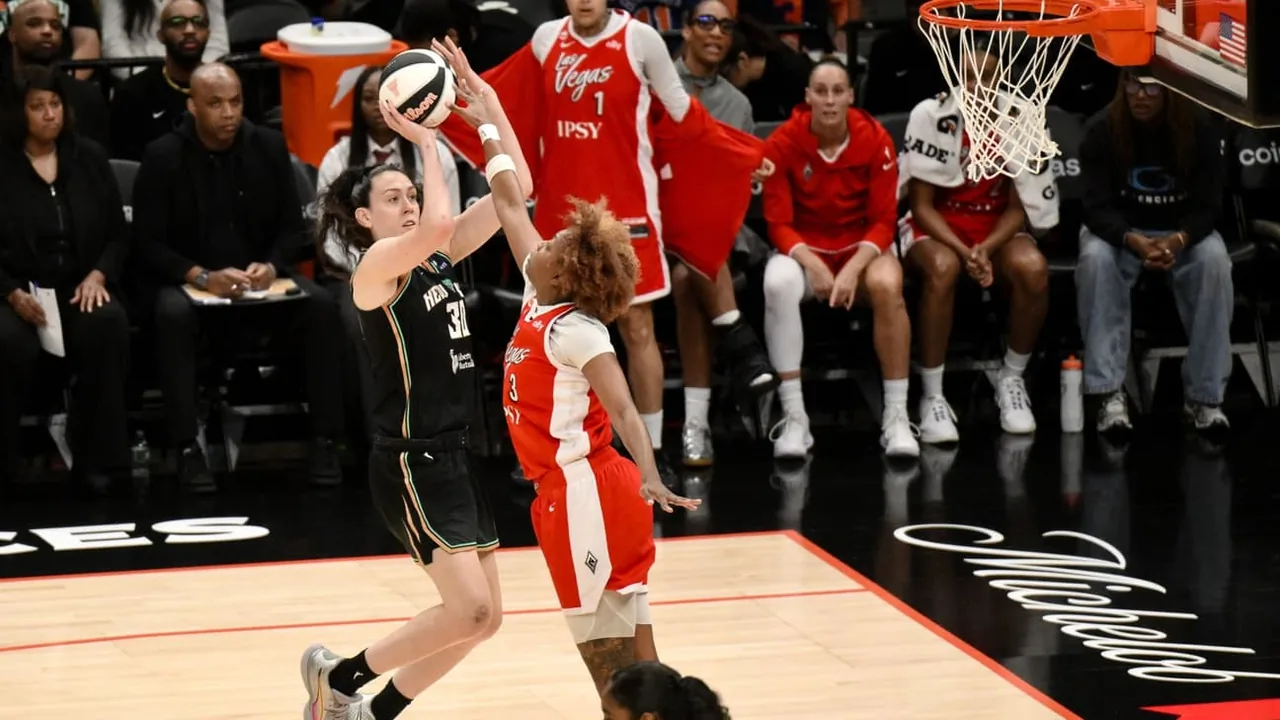 New York Liberty player shooting over a Las Vegas Aces defender in the 2026 Commissioner's Cup final